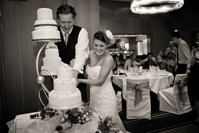 bride and groom cutting wedding cake. Tara Aherne Photography cutting wedding cake photography